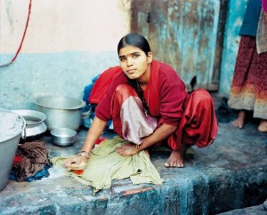 Whagri woman washing used clothing for resale